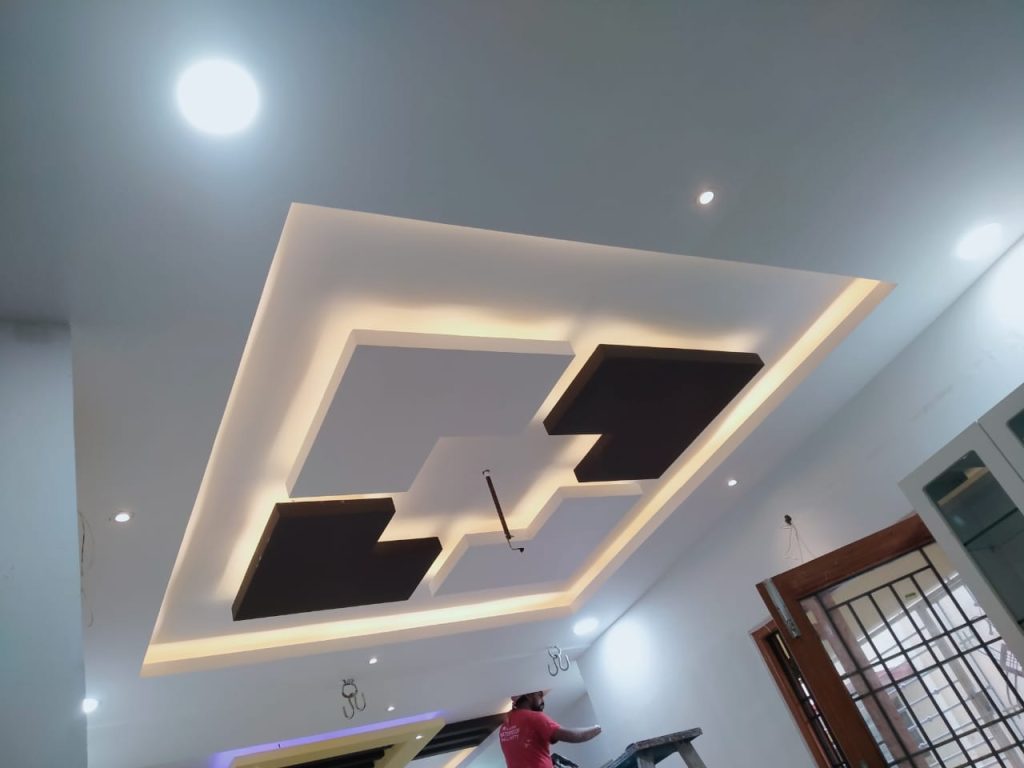 Modern and stylish false ceiling with geometric design and ambient cove lighting by Galaxy Interior Designers