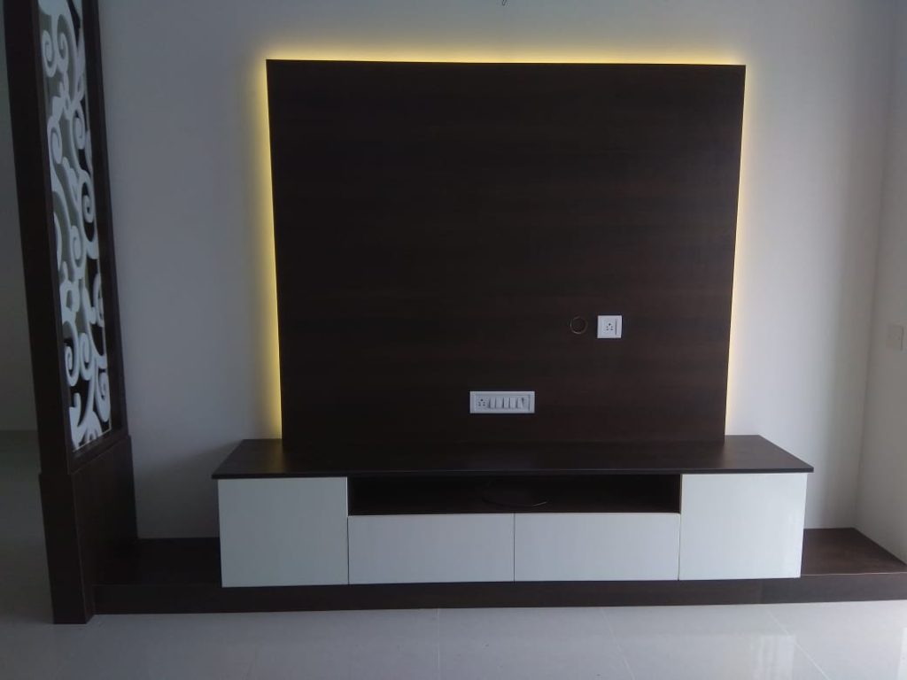 Sophisticated and stylish dark wood TV unit with glass cabinet doors and ample storage, by Galaxy Interior Designers