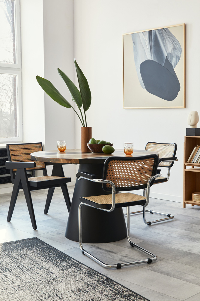 Elegant and minimalist office interior setup by Galaxy Interior Designers, showcasing a stylish combination of modern chairs and a sleek table