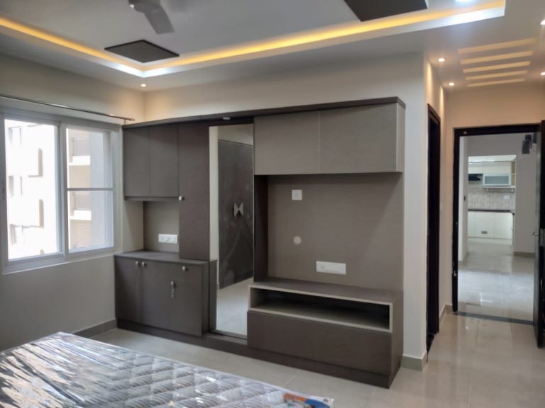 Sleek and modern storage solution with integrated seating and ambient cove lighting, custom-designed by Galaxy Interior Designers