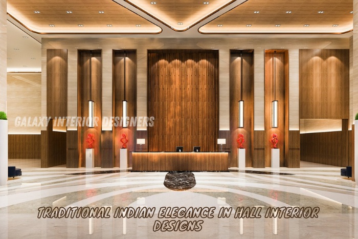 Luxurious hall interior design featuring traditional Indian elegance with wooden paneling and contemporary lighting by Galaxy Interior Designers in Chennai