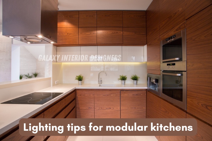 Contemporary modular kitchen lighting design by Galaxy Interior Designers in Chennai featuring warm under-cabinet lights