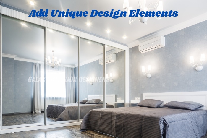 Bedroom interior with large mirrored wardrobes designed by Galaxy Interior Designers in Chennai, featuring soft lighting